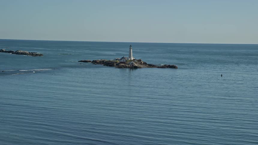 A tower and isolated buildings on a small island
