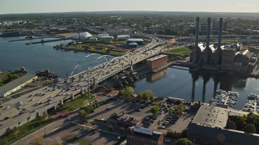 A bridge with many cars that passes over a river