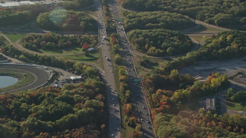A very busy highway with lots of cars and forest