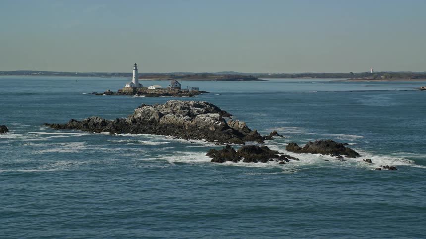 Aerial view of a lighthouse built over a promontory near the coast