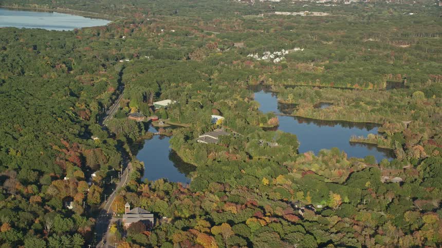 Aerial panorama of residential houses amidst nature and a river