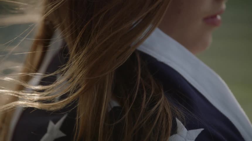 A woman's hair is blowing in the wind