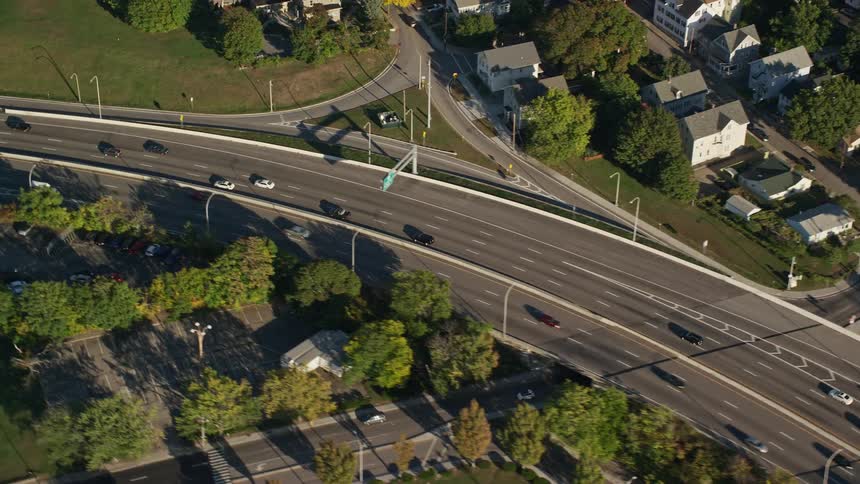 Traffic moves along roads through suburban landscape