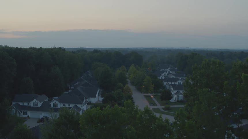 Reveal of a quiet and sleepy residential neighborhood at dawn