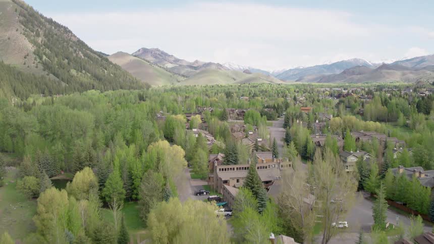Ascent above a mountain valley community filled with homes and condos