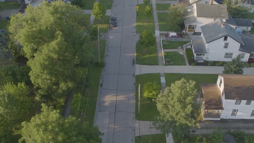 Birds eye view of working class homes on a peaceful neighborhood street in morning light