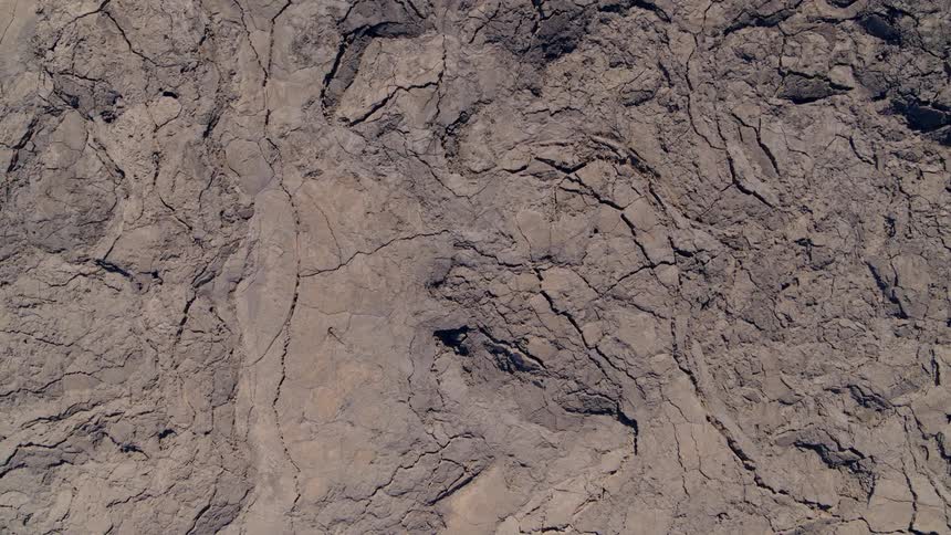 Rising overhead view of the intricate texture of a pahoehoe lava field