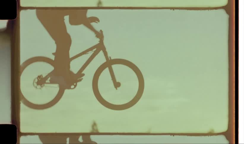 A bmx rider jumps over a hill