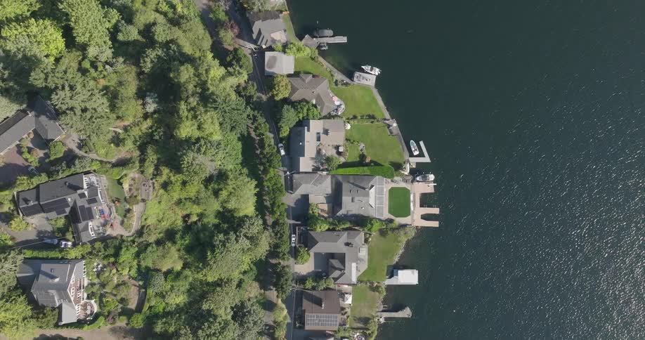 Top down view of waterfront homes along a sparkling lake