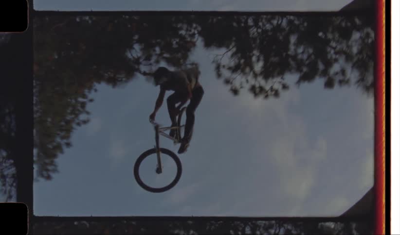 Person riding a bicycle doing stunts on a ramp at morning