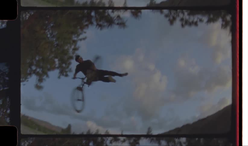 Person riding a bicycle doing stunts on a ramp at morning