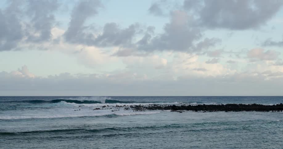 Panorama of a beach with waves in motion during the day