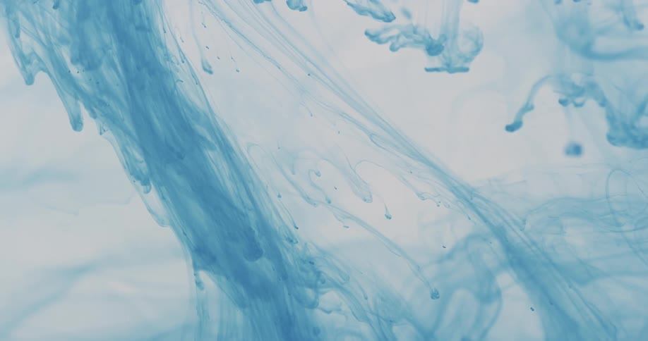The blue ink floats down in the water