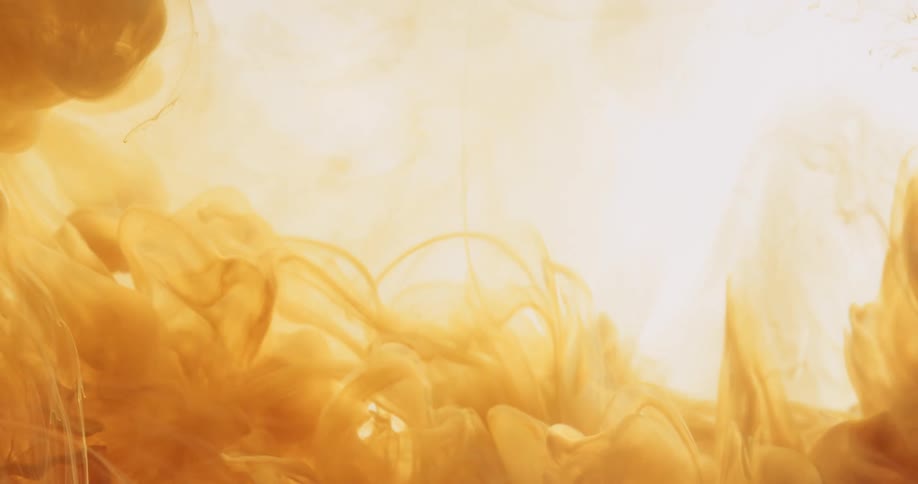 A cloud of yellow paint emerging from left to right and dispersing into a clear liquid