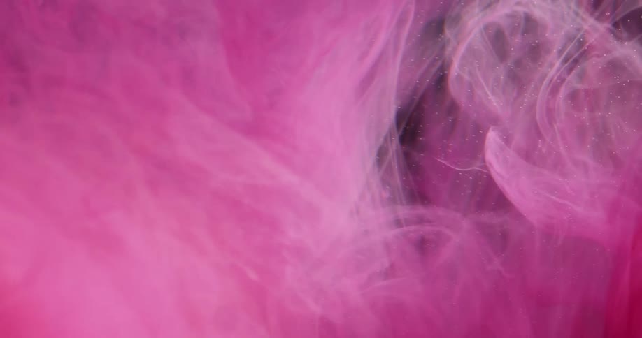 A pink liquid swirls around within a clearer one and spreads out