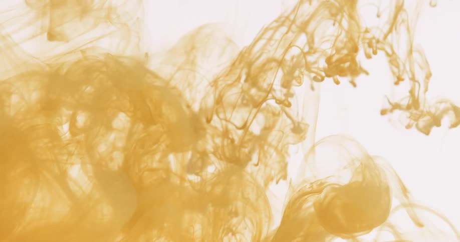 Cloud of yellow ink flows down on a white background