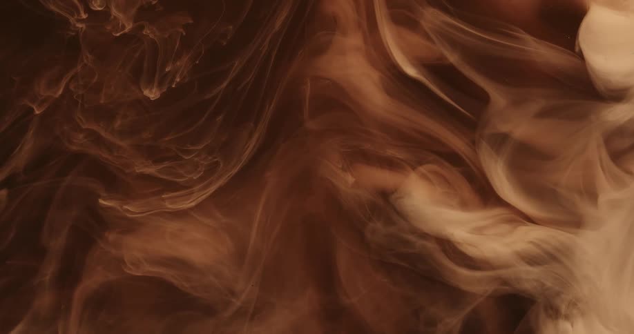 Cloud of cream and brown ink floating and mixing