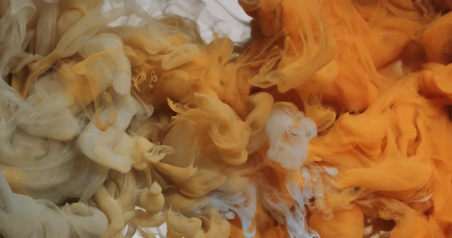 Cloud of colorful inks mixing on a white background