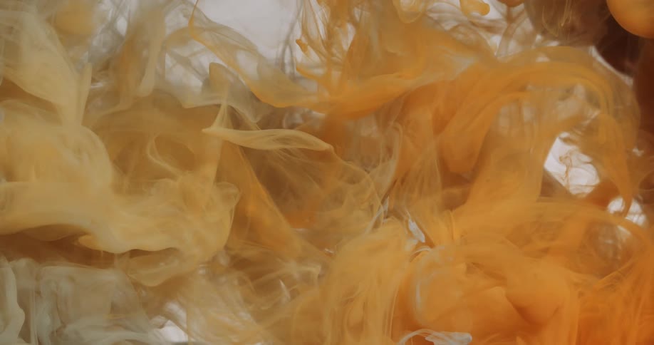 Yellow dye spreads through clear liquid