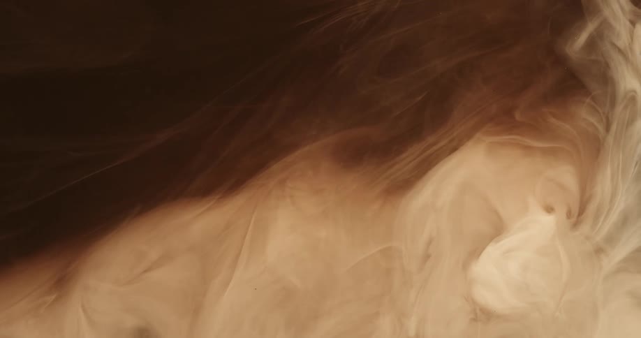 Cloud of turbulent cream and brown liquid ink