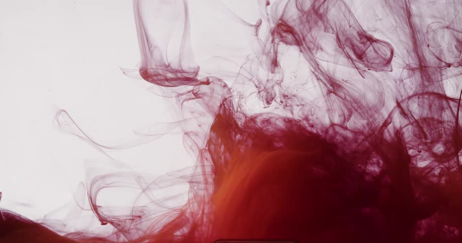 Slowmoving red ink fluid on a white background