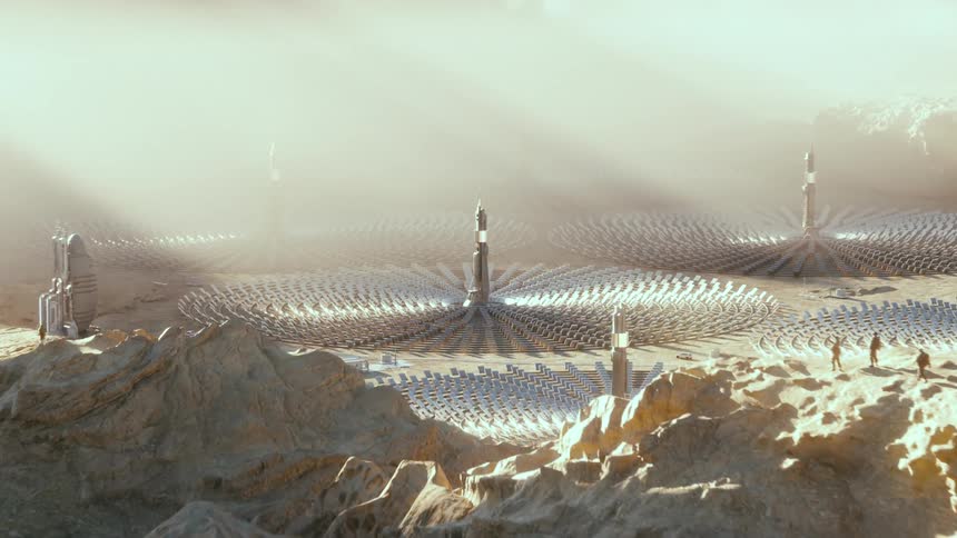 Sun shines over the towers of a large solar farm