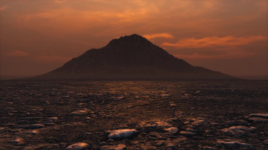 A solitary mountain in the desert at sunset