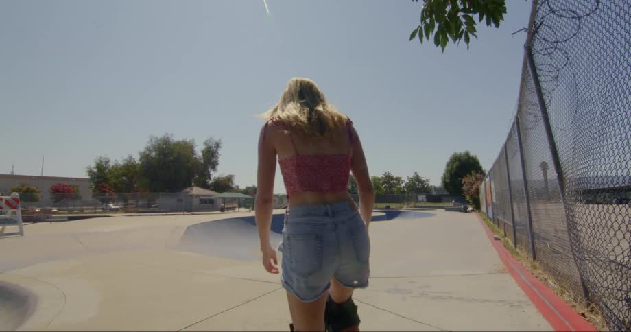 A woman skateboards in the park