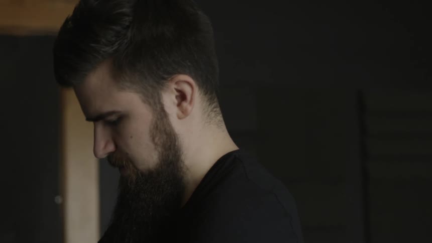 A man is looking down working on something