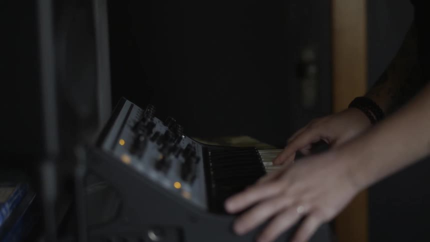 A man is using a electronic keyboard