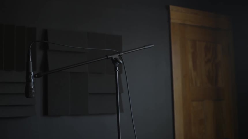 A microphone is hanging in a studio