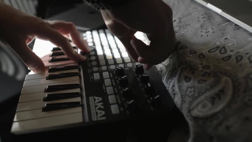 A person is adjusting knobs on a keyboard