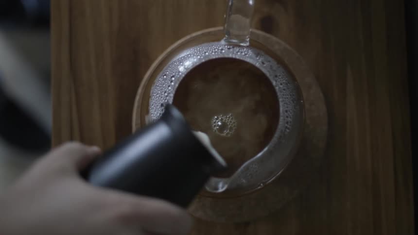 Milk is being poured into a pitcher