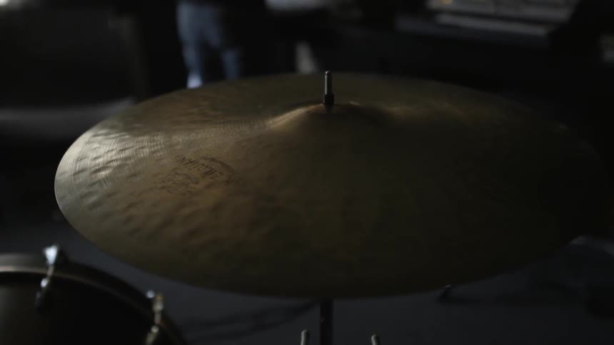 A drum cymbal sits in a studio