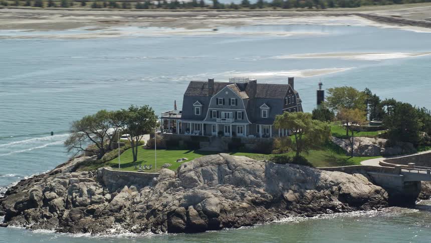 Aerial view of house on peninsula surrounded by water
