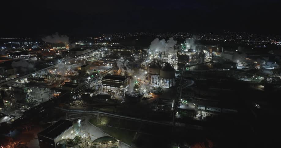 Aerial view night work site silos steam