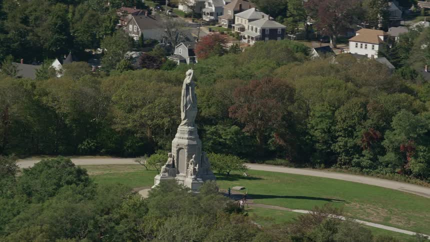 People are walking near the national monument to the forefathers in plymouth massachusetts