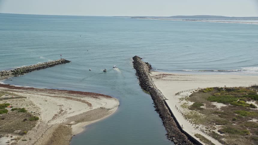 A river with several boats that is connected to the open sea
