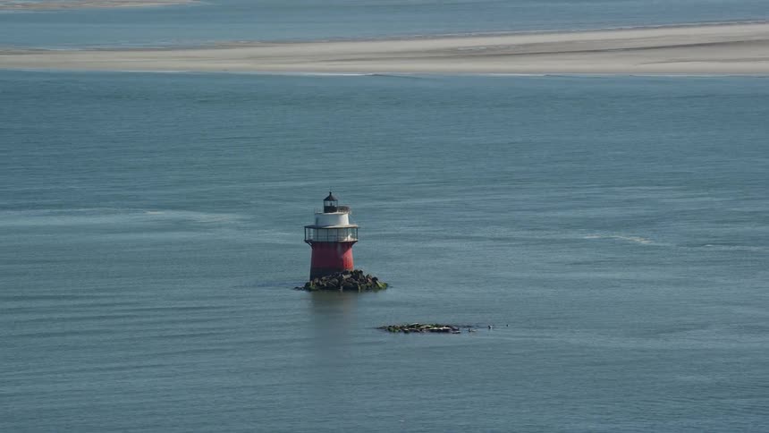 Aerial view of lighthouse surrounded by water