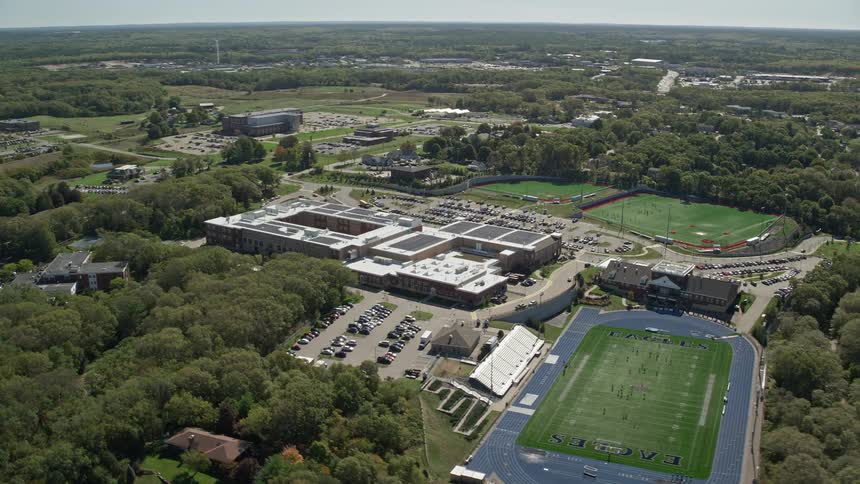 Aerial view of a sports arena and the adjacent football baseball and soccer fields on a sunny summer day