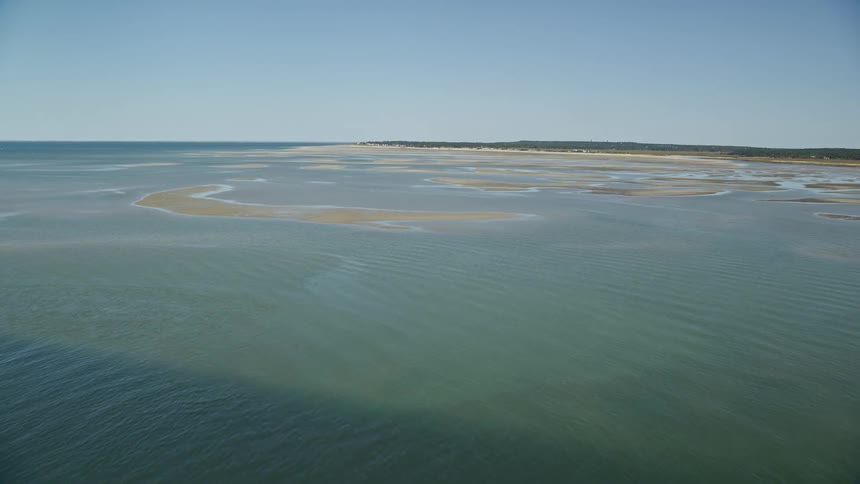 Aerial view of open ocean and sand bar
