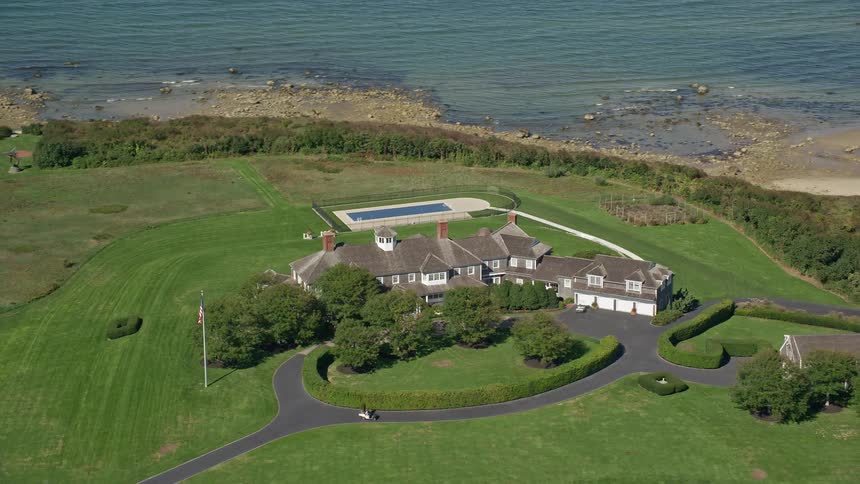Aerial of a mansion on the beach coast during a hot day
