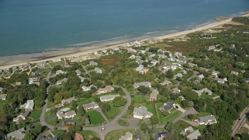 Aerial of residential neighborhood bordering beach and lake