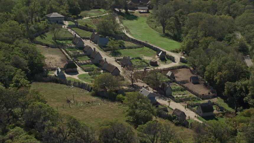 A small residential village in the middle of trees and next to a lake