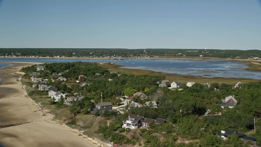 A small rural town on an island surrounded by aguja in with forest on the island