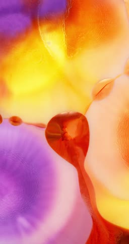 Colorful inks mixing into an abstract pattern in vertical direction