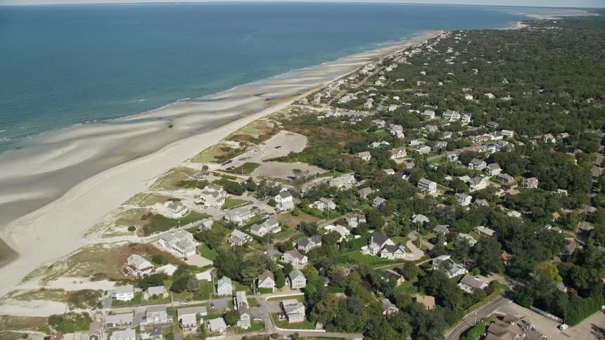 Aerial view of a coastal town at an ocean beach on a sunny day