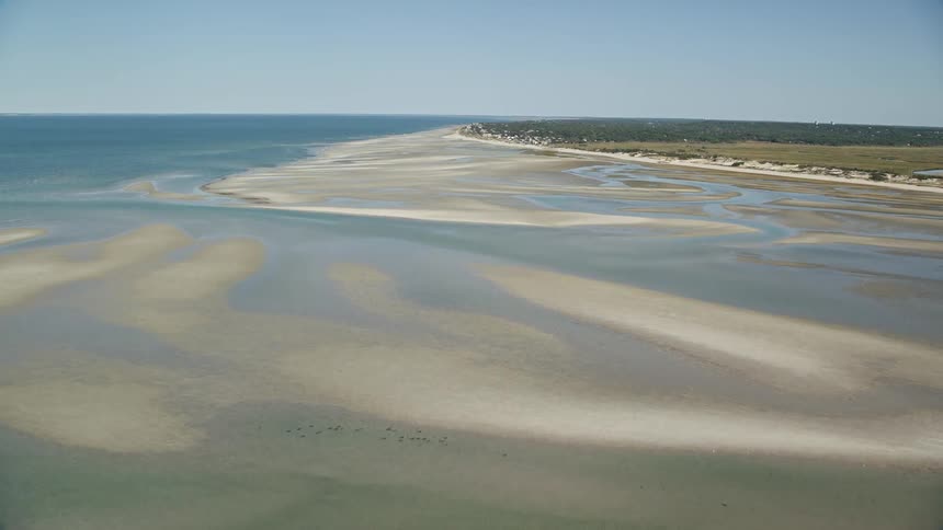 A coastal region with pools of ocean water amid sandbanks