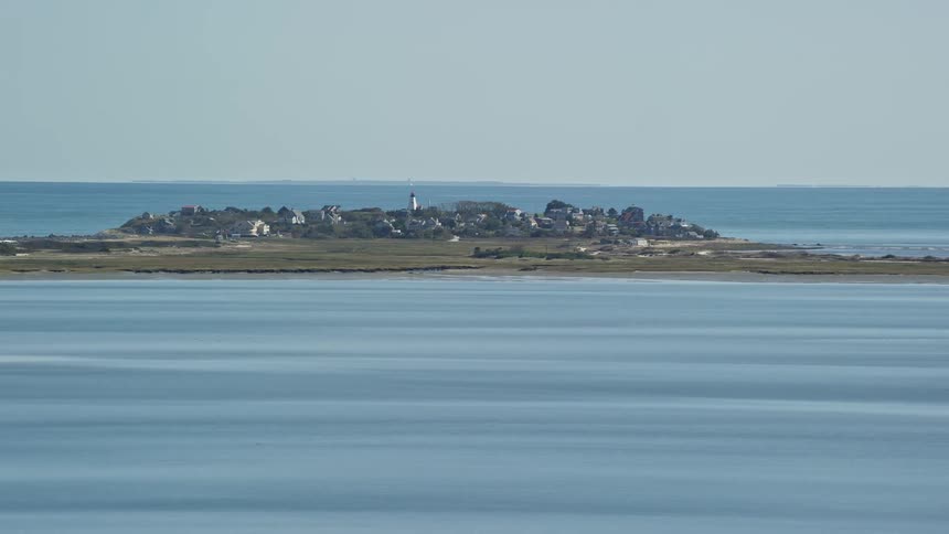 An island with rocks on top surrounded by a blue sea