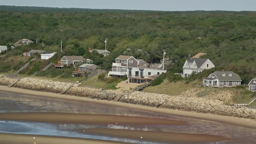 Houses in a neighborhood along the coast overlook sand bars during low tide